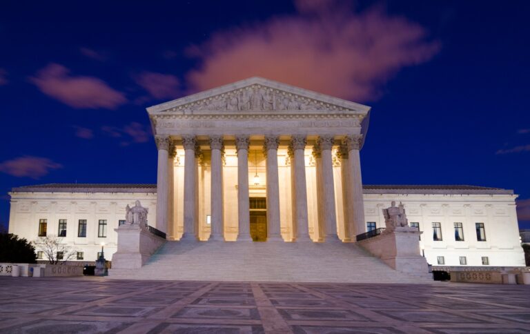 US Supreme Court building illuminated at night